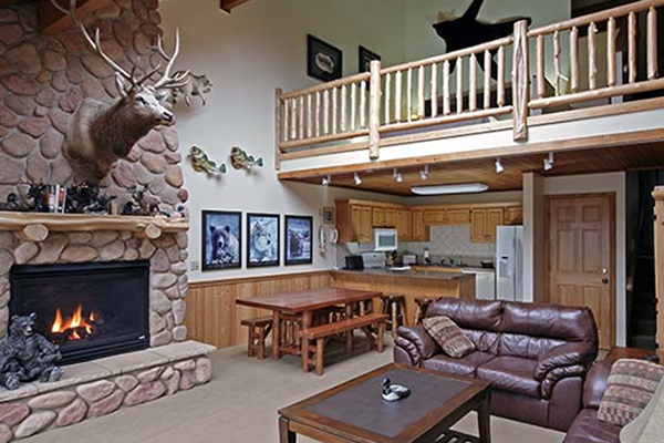 Cabin living room with high ceiling and deer mount