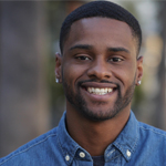 a smiling man with short dark hair, labeled as Book Aficionado